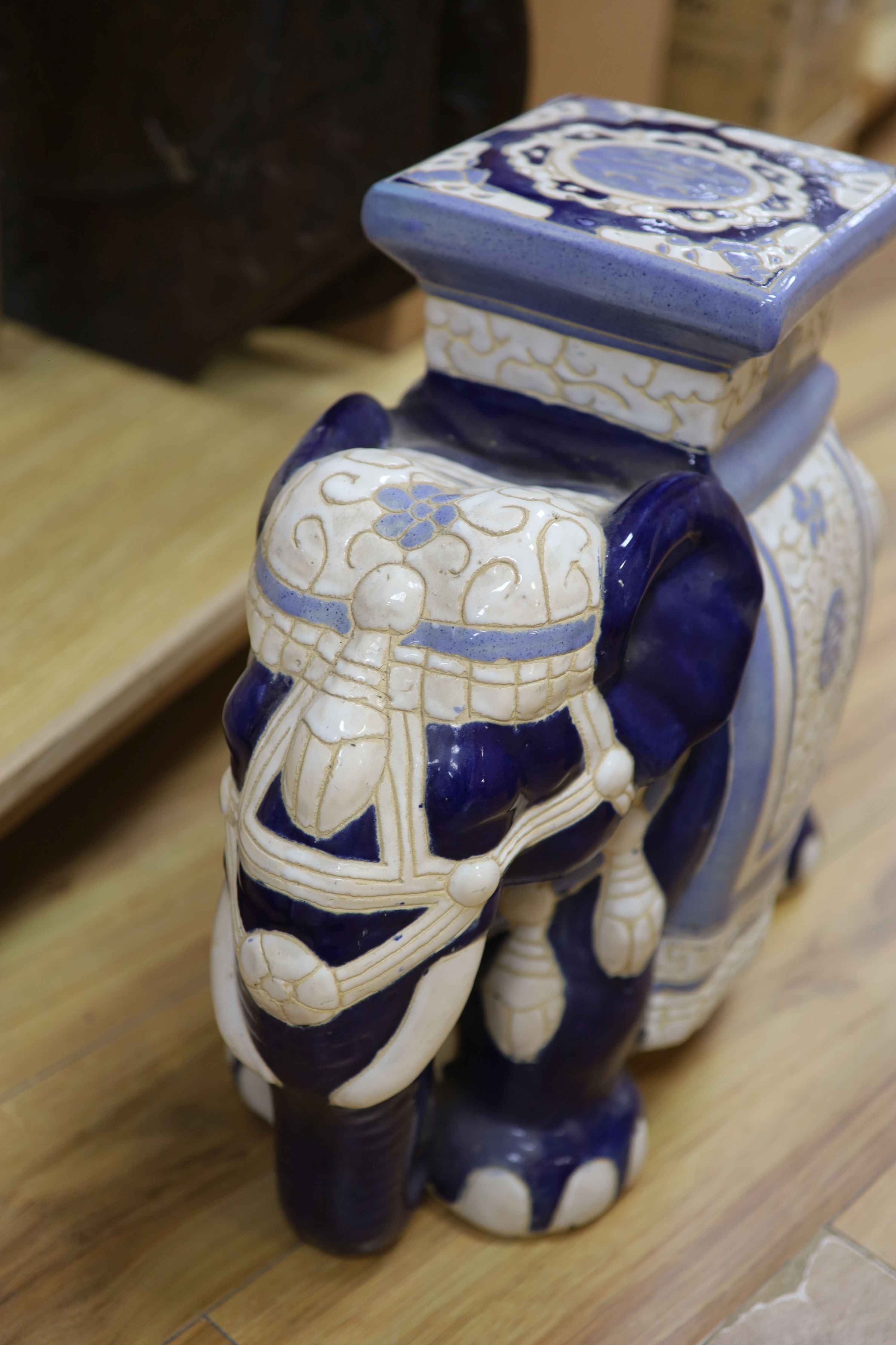 Two Chinese ceramic elephant garden seats and a blue and white stick stand, height 61cm